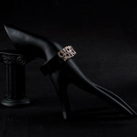 Side angle view of KHAISTA black round designer crystal bangle