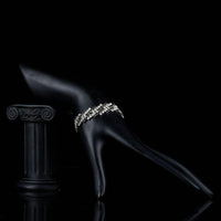Side angle view of KHAISTA black zig zag CZ bracelet