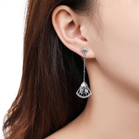 Close up of KHAISTA blue Austrian crystal drop earrings