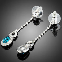 Close up of KHAISTA blue Austrian crystal drop earrings