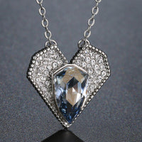 Close up detail of KHAISTA blue Austrian crystal vintage heart necklace