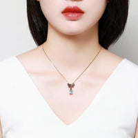 Close up detail of KHAISTA blue Austrian crystal pendant necklace