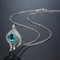 Close up detail of KHAISTA blue crystal pendant chain necklace
