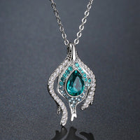 KHAISTA blue crystal pendant chain necklace on white background