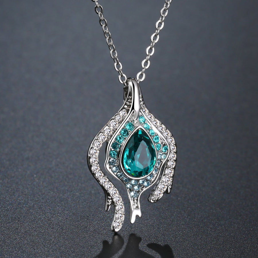 KHAISTA blue crystal pendant chain necklace on white background