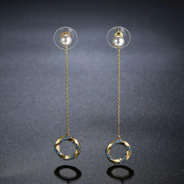 KHAISTA blue CZ pearl dangle earrings on white background