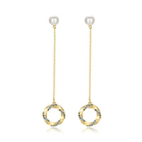 Side angle view of KHAISTA blue CZ pearl dangle earrings