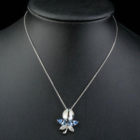 Close up detail of KHAISTA blue crystal dragonfly pendant necklace