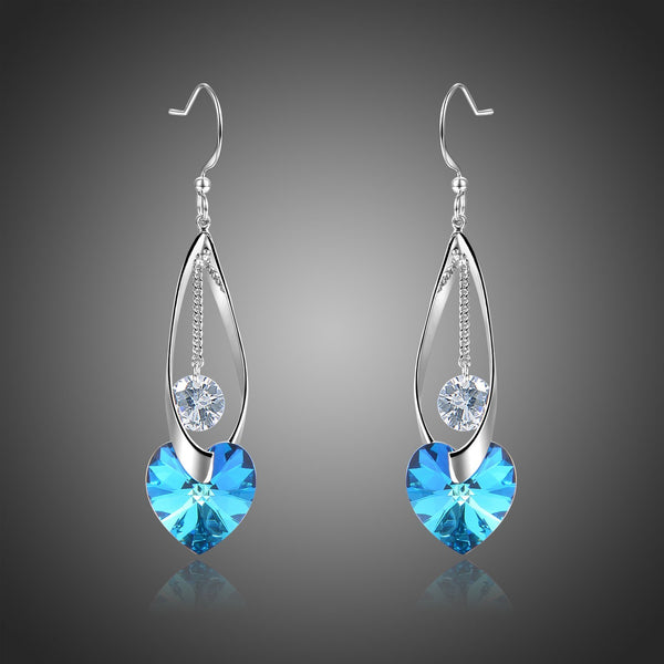 KHAISTA blue heart crystal drop earrings on white background