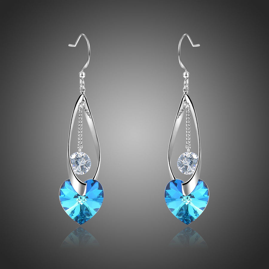 KHAISTA blue heart crystal drop earrings on white background