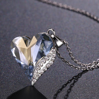 Pendant detail on KHAISTA blue crystal heart dangle pendant necklace