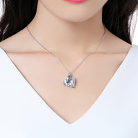 Close up detail of KHAISTA blue crystal heart dangle pendant necklace