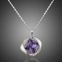 KHAISTA blue crystal love pendant necklace on white background