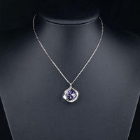 Close up detail of KHAISTA blue crystal love pendant necklace