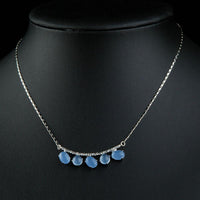 Close up detail of KHAISTA blue resin Austrian crystal pendant necklace