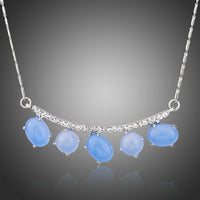 KHAISTA blue resin Austrian crystal pendant necklace on white background