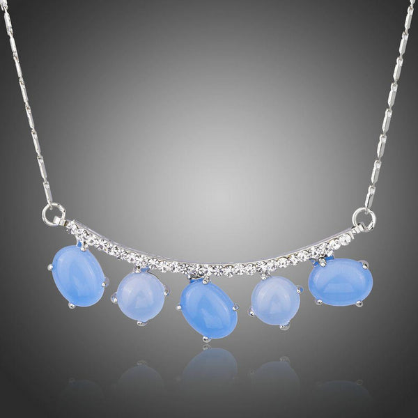 KHAISTA blue resin Austrian crystal pendant necklace on white background