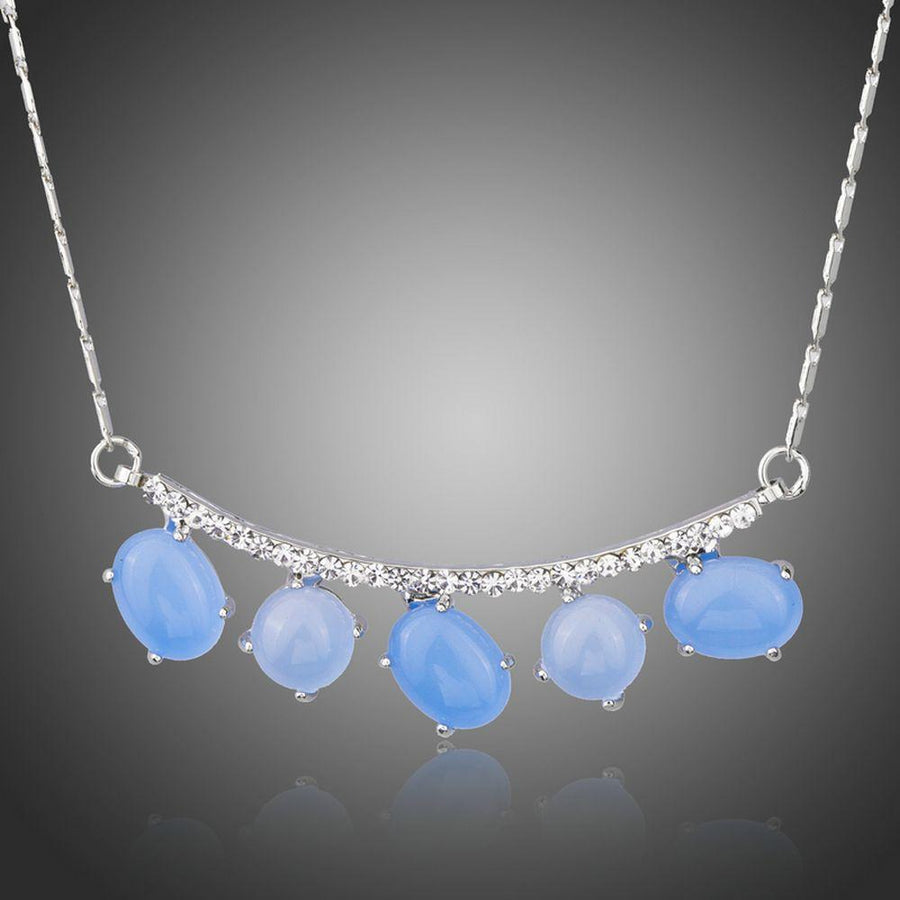 KHAISTA blue resin Austrian crystal pendant necklace on white background