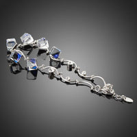 Close up detail of KHAISTA blue square crystal charm bracelet
