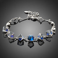 KHAISTA blue square crystal charm bracelet on white background
