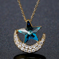 Close up detail of KHAISTA blue star gold moon chain necklace