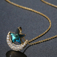 Pendant detail on KHAISTA blue star gold moon chain necklace