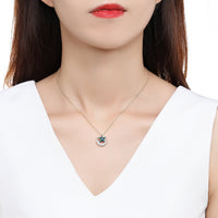 Side angle view of KHAISTA blue star gold moon chain necklace