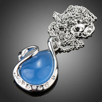 Close up detail of KHAISTA blue crystal swan pendant necklace