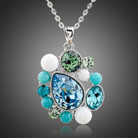 KHAISTA blue teardrop Stellux Austrian crystal necklace on white background