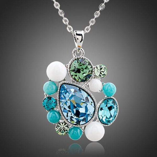 KHAISTA blue teardrop Stellux Austrian crystal necklace on white background