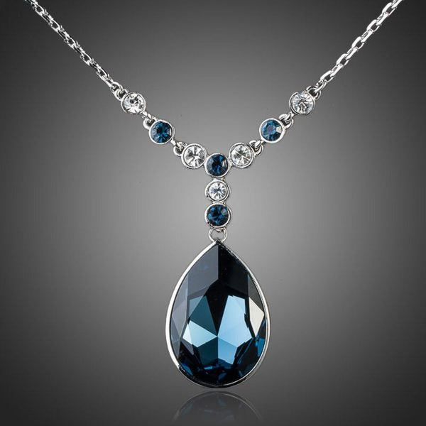 KHAISTA blue water crystal pendant necklace on white background