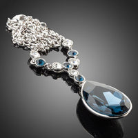 Close up detail of KHAISTA blue water crystal pendant necklace