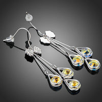 Close up of KHAISTA bow knot crystal drop hoop earrings