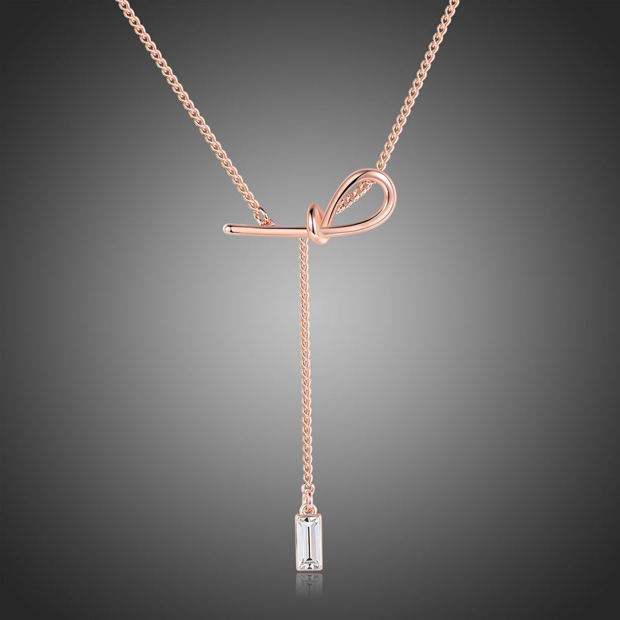 KHAISTA crystal bow knot pendant necklace on white background