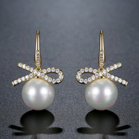 pearl bow knot dangle drop earrings detail view by KHAISTA