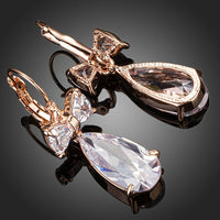 Close up of KHAISTA bow knot CZ drop earrings