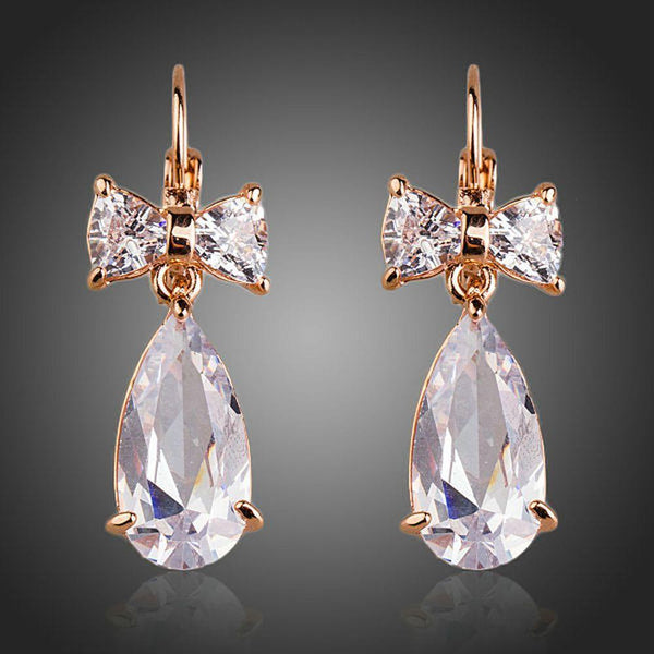 KHAISTA bow knot CZ drop earrings on white background