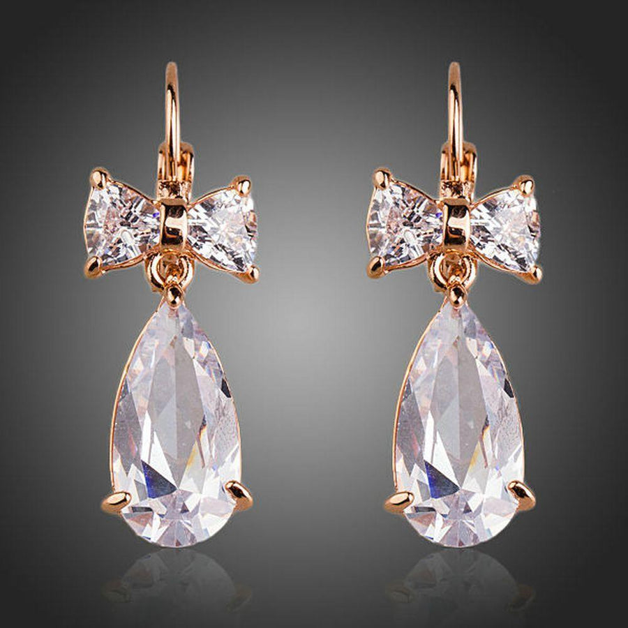 KHAISTA bow knot CZ drop earrings on white background