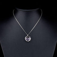 Close up detail of KHAISTA white gold bud Stellux crystal necklace
