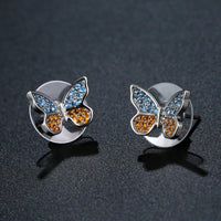 Close up of KHAISTA butterfly cubic zircon stud earrings