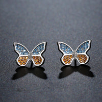 Side angle view of KHAISTA butterfly cubic zircon stud earrings