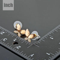 gold Stellux butterfly stud earrings detail view by KHAISTA