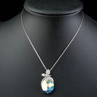 Close up detail of KHAISTA butterfly on crystal pendant necklace