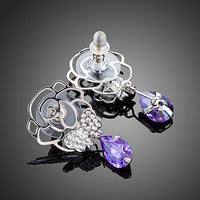 Close up of KHAISTA butterfly on flower crystal drop earrings