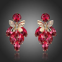 KHAISTA crystal butterfly raspberry drop earrings on white background
