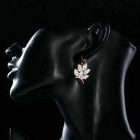 Side angle view of KHAISTA butterfly shaped CZ drop earrings