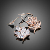 Close up of KHAISTA butterfly shaped CZ drop earrings