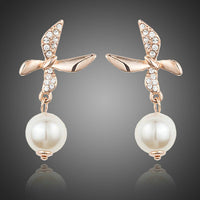 KHAISTA butterfly pearl drop earrings on white background