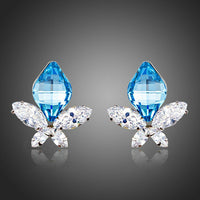 KHAISTA sea blue crystal butterfly stud earrings on white background