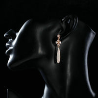 Side angle view of KHAISTA cactus flower crystal drop earrings
